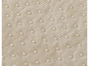 Close-up detail of beige non-slip sofa cushion backing with dotted silicone grip texture.