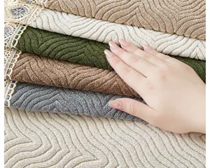 Chenille sofa cover detail with elegant lace trim, soft textured fabric for modern living room.