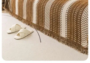 Detailed view of the brown and beige chenille sofa cover with stylish fringe and geometric pattern.