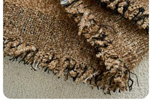 Detailed macro view of retro striped furry yarn sofa cover fabric texture and fringe.