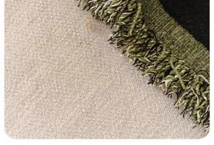 Nahaufnahme des Chenille-Sofatuches mit gewebter Textur und dekorativen Quasten.