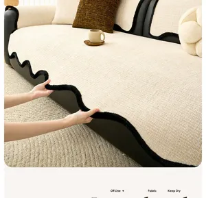 Cream chenille sofa cover detail, soft textured fabric with black plush wavy edge design.