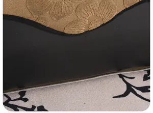 Sofa cushion detail shot, textured chenille and leather patchwork, mid-century modern style.