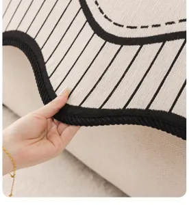 Detailed shot of retro style chenille sofa cover with black and white vertical stripes.