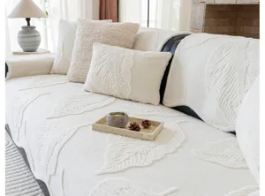 Cozy plush leaf pattern sofa cover detail shot, soft textured living room decor fabric.
