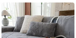 Cozy grey velvet sofa cover featuring elegant embossed leaf design, perfect for modern living room.