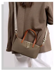 Nylon crossbody bag detail view, mini shoulder handbag with brown handle and printed strap.