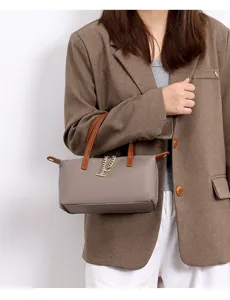 Mini nylon crossbody bag with brown leather handles and chic chain decoration for women.