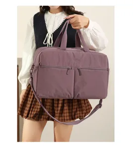 Detail view of purple travel gym bag with multiple zippered pockets and shoulder strap.