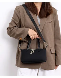 Detail view of the black mini nylon crossbody bag featuring woven strap and metal zippers.