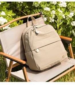 Detailed view of casual beige backpack on outdoor camping chair, lightweight and stylish.