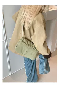 Multi-layer nylon crossbody bag for women, lightweight casual shoulder bag with front pockets.