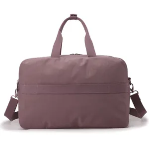 Detail shot of the mauve travel duffel bag showing smooth nylon fabric and sturdy handles.