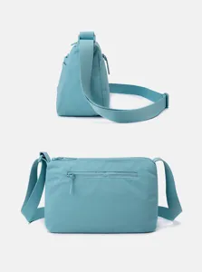 Nylon crossbody bag detail showcasing multi-layer pockets and durable adjustable shoulder strap.