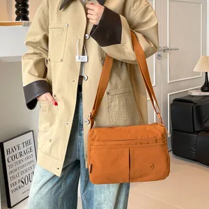 Casual multi-pocket canvas crossbody bag for women, stylish daily shoulder bag with adjustable strap.