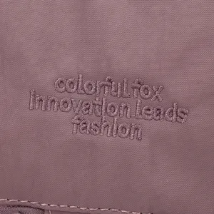 Detail shot of gym bag fabric texture and logo embroidery, featuring dry wet separation storage design.