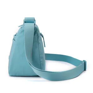 Light blue nylon multi-pocket crossbody bag detail view, casual lightweight shoulder bag.