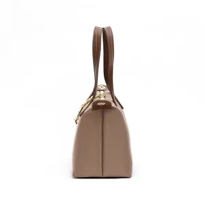Detail view of the stylish waterproof nylon mini shoulder and handbag in brown color.