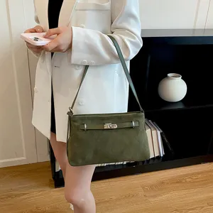 Green suede shoulder bag for women, chic commuting handbag with turn lock closure and strap.