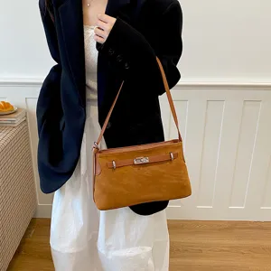 Chic brown suede shoulder bag for women, elegant commuter handbag with metal lock design.