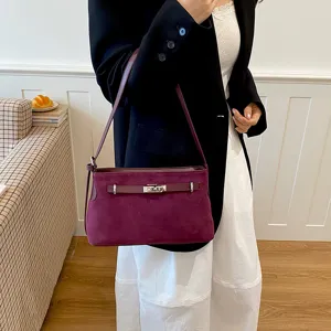 Burgundy suede shoulder bag for women, stylish commuter tote bag with metal lock closure.