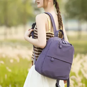 Close-up detail view of the purple casual backpack featuring durable fabric and smooth zippers.