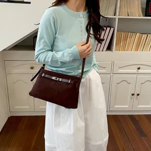 Brown suede shoulder crossbody bag detail, stylish vintage commuter bag daily scene view.