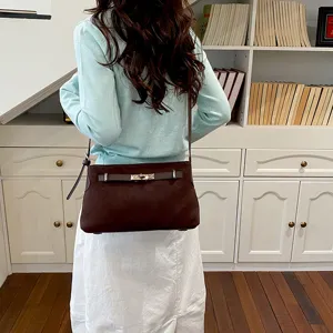 Brown suede shoulder bag detail, stylish commuter crossbody handbag with turn-lock hardware.