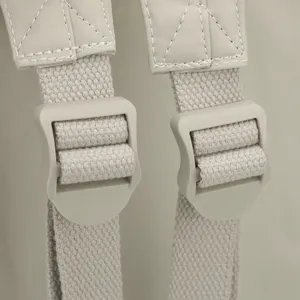 Backpack strap detail showing adjustable plastic buckle and durable woven nylon fabric.