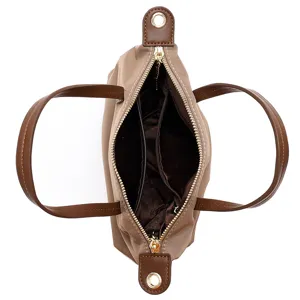 Waterproof nylon mini shoulder bag with top handles, classic fold design, detail view interior.