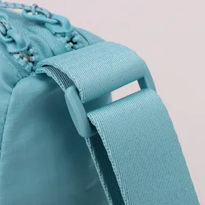 Nylon crossbody bag shoulder strap and adjustable buckle hardware detail close-up view