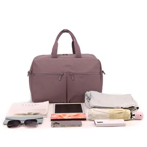 Travel duffel bag capacity detail showing organized compartments, clothes, electronics storage.