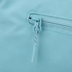 Detailed shot of lightweight multi-layer crossbody bag zipper and grid fabric texture.
