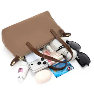 Detailed interior view of the brown nylon handbag showing practical daily storage capacity.