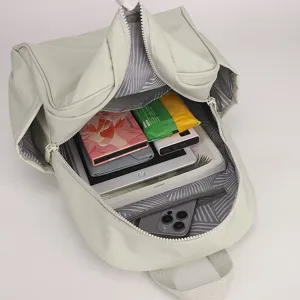 Grey nylon backpack detail showing spacious interior storage capacity for daily use.