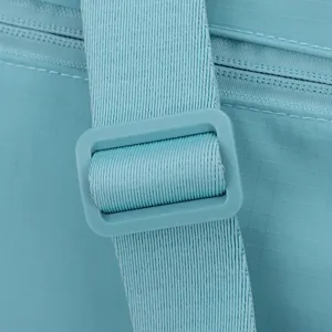 Detail shot of the adjustable strap and zipper on a light blue casual crossbody bag.
