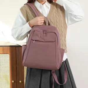 Detailed view of the large capacity nylon backpack, showing multiple pockets and durable straps.