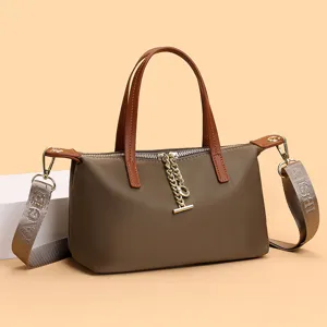 Waterproof nylon handbag with brown handles and chic chain pendant for women stylish daily use
