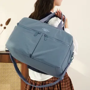 Large capacity travel duffel bag for women, waterproof gym fitness sports bag with shoulder strap.