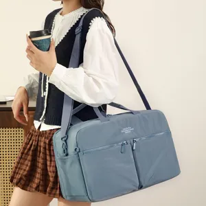 Blue large capacity travel duffel bag with shoulder strap and multiple zipper pockets.