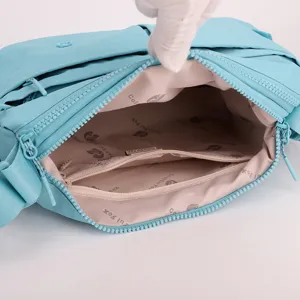 Lightweight casual multi-layer crossbody bag interior compartment detail for women.