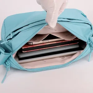 Interior detail of light blue multi-layer crossbody bag showing spacious storage compartments.