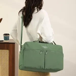 Green travel duffel bag for women, large capacity gym bag with shoulder strap and front pockets.