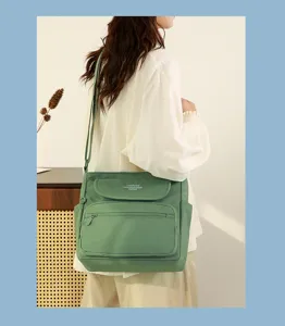 Green cross-body shoulder bag for women, multi-pocket stylish casual messenger handbag daily use.
