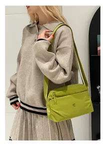 Casual multi-layer canvas crossbody shoulder bag in light green, versatile daily accessory.