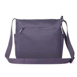 Close-up detail of the durable zipper pocket and adjustable strap on this chic purple shoulder bag.