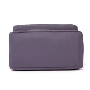 Detail view of the bottom structure of this versatile purple crossbody bag, showing fine fabric.