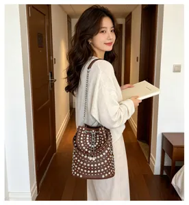 Fashionable litchi grain rivet bucket bag with chain strap and dazzling rhinestones for women.
