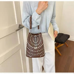 Rhinestone rivet bucket bag detail view, brown leather shoulder handbag with sparkling crystal studs.