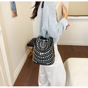 Black rhinestone bucket bag for women, sparkling studded design with chain strap, stylish shoulder bag.